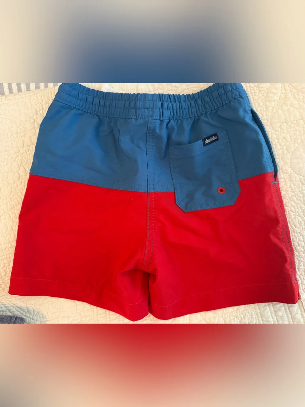 Chubbies swim trunks.  Boys 4T.  Red and blue color block with stars (in water)